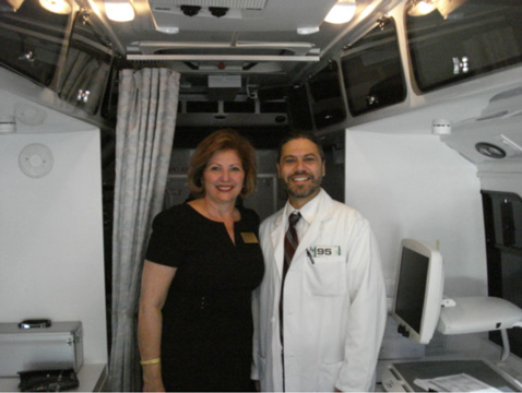 Representative Janet Cruz and Dr. Bryan Wolynski inside Heiken mobile unit at Tampa Bay Boulevard Elementary