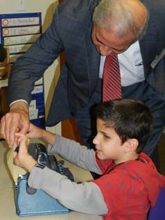 Mayor Regalado feels Braille typed by STAR summer camp program student
