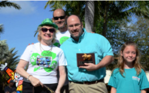CEO Virginia Jacko, Chairman of the Board Agustin Arellano Jr., with Dr. Greg Frishman of Brickell Bay Animal Hospital and his daughter