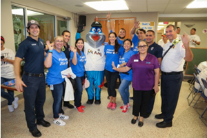 Representatives from Florida Blue and City of Miami Department of Fire Rescue with Grand Marshall Billy the Marlin.