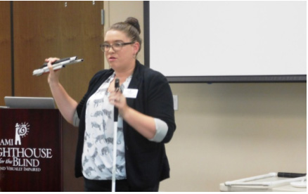 Miami Lighthouse Certified Orientation and Mobility Specialist Lauren Bowen speaks to attendees about safe ambulation using a white cane.