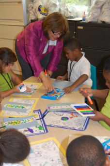 Child in the STAR Summer Program shows Commissioner Bell a Father’s Day card