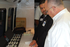 Dr. Wolynski shows Representative Hudson the different frames offered to the students